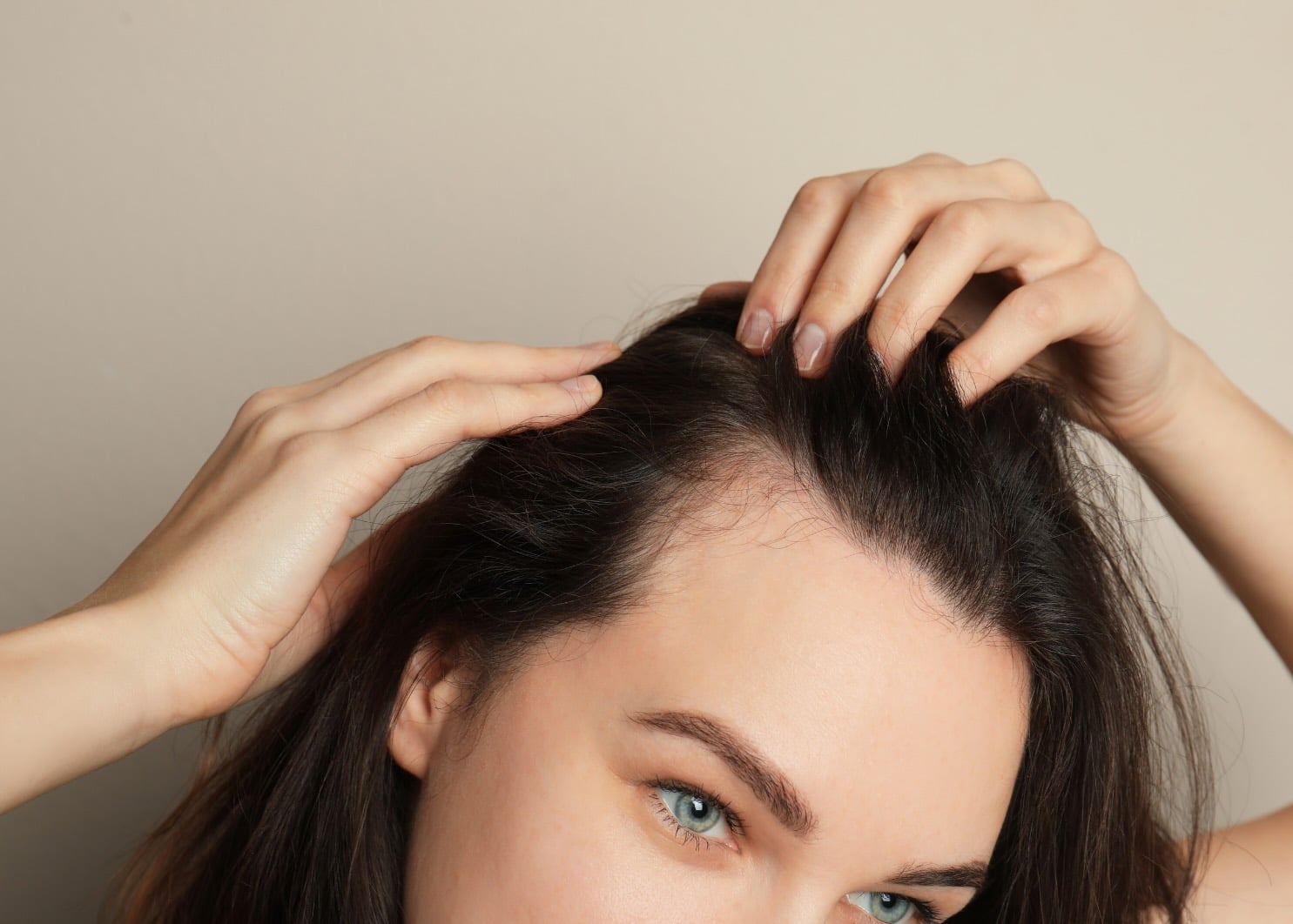 Image of women looking at her hair