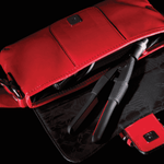 Red Handbag showing a WAM Mini straightening Iron inside. 
