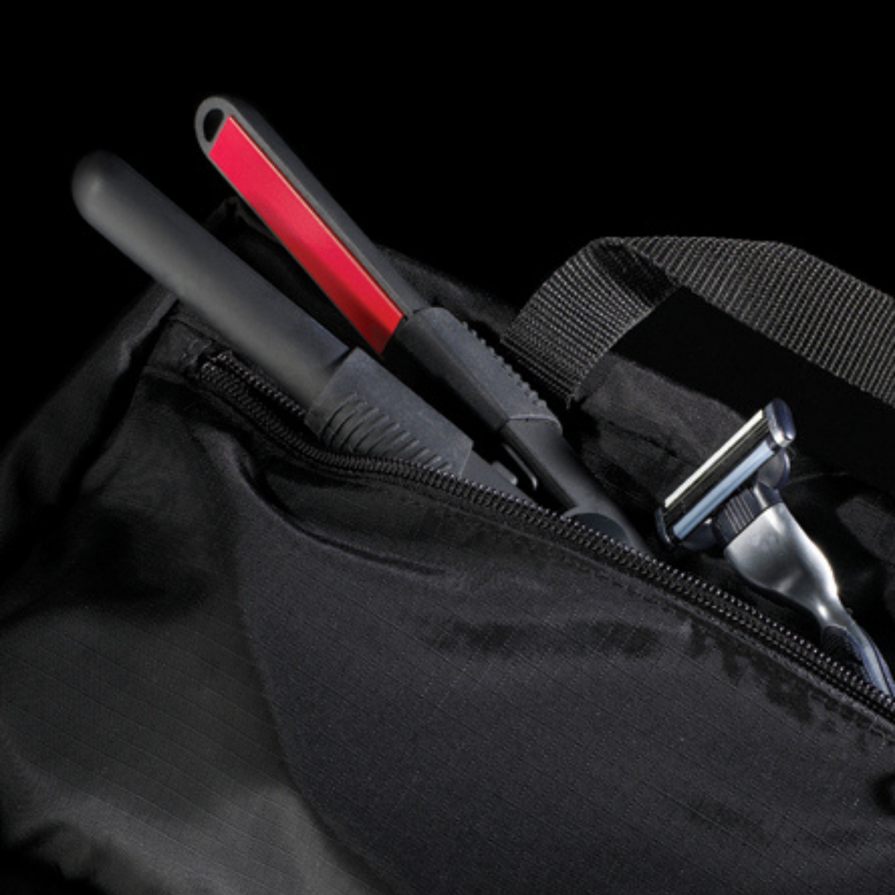 Image of WAM Mini Irons inside a man's shower bag along with razor. 